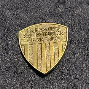 Lapel or Jacket Pin. “Professional Ski Instructor of America”. Bronze finish